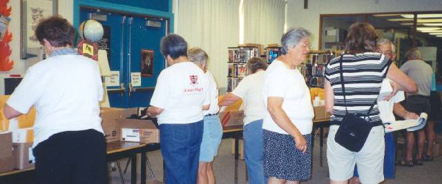 Stuffing and Sorting Registration Envelopes.  
Rachel (Parkes) Long, Kay (Nagai) Mori, Susie (Normand) Haughton :: Click image to download full-sized image