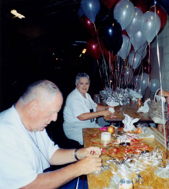 Sam Scott and Isabell (McKague) Bagg help with baloons :: Click image to download full-sized image